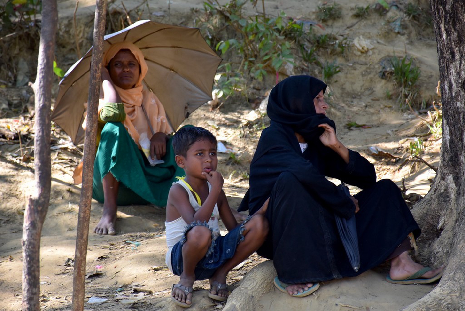 A group of Rohingya women and children waits for food