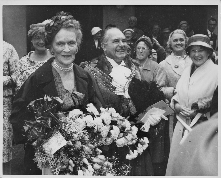 Lady Nancy Astor with Lord Mayor Washbourn, holding a large bouquet of flowers as she is greeted by well-wishers, following the ceremony to make her the first woman presented with the Freedom of the City of Plymouth, England, July 17th 1959. Photo by Central Press/Hulton Archive/Getty Images