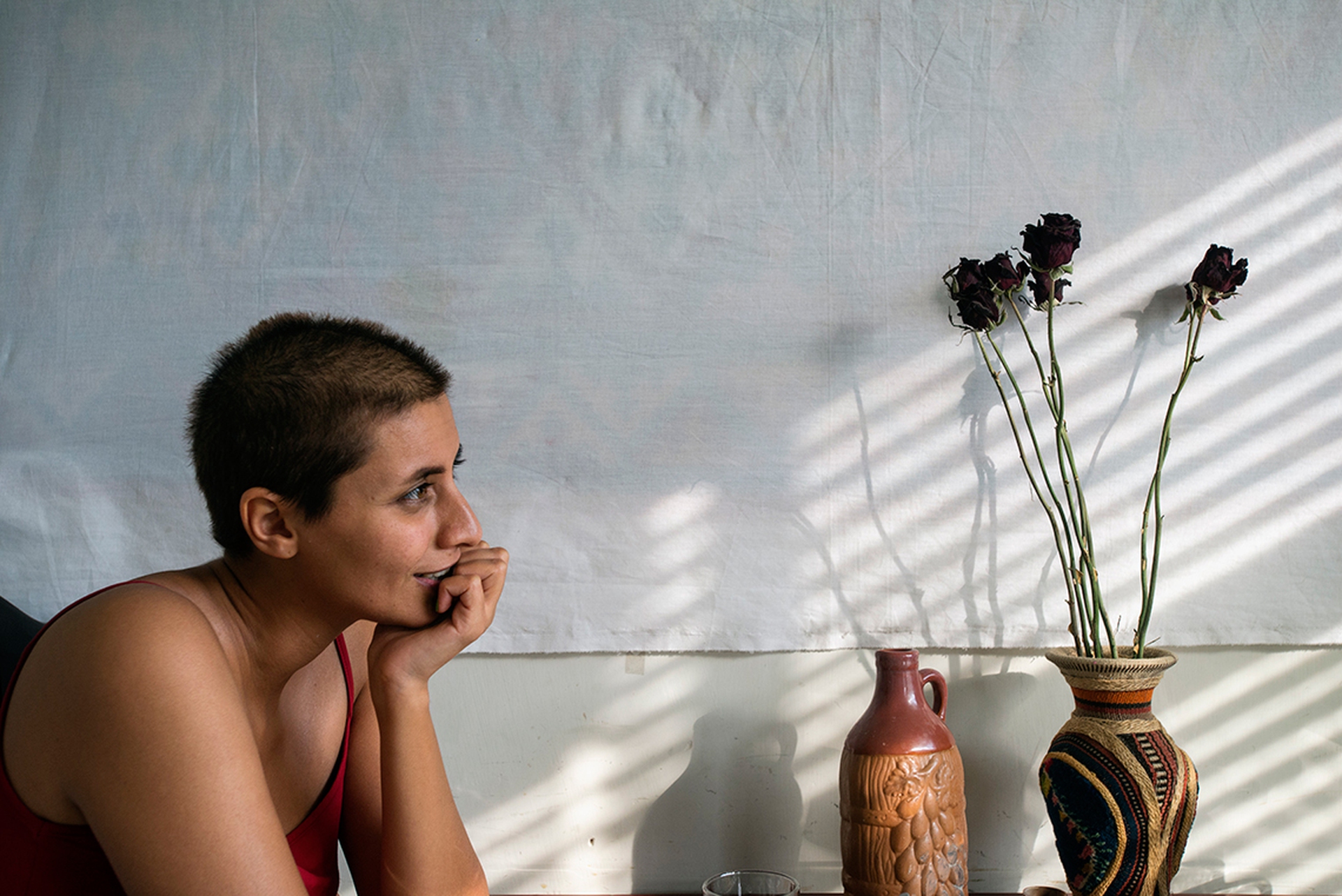 Maryam, young teacher of physics, sits at the table in her apartment