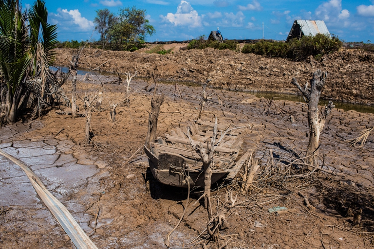 BEN TRE PROVINCE, VIETNAM - MAY 04: A boat in a dried out shrimp farm on May 04, 2016 in Ben Tre Province, Vietnam.  Vietnam's Mekong Delta had been hit by its worst drought in 90 years caused by the El Nino weather patterns and hydroelectric dams. Based on reports, nearly 140,000 hectares of the Mekong Delta in Vietnam are bone dry and contaminated by salt water, as brine from the sea pushes up the delta's channels. People in affected regions are growing desperate to find water for basic needs and huge amount of the crops for the coming harvest in Vietnam's Mekong Delta, which produces about half of the country's rice, have been spoiled.   (Photo by Christian Berg/Getty Images)