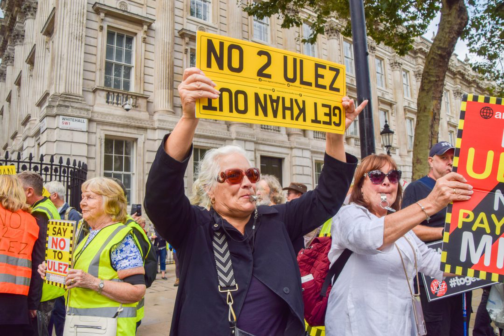 A protester holds an anti-ULEZ placard during the