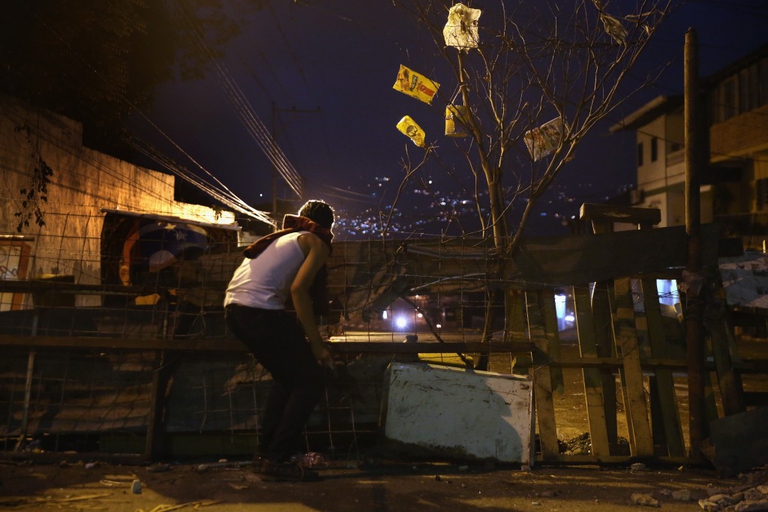 I protestanti fuggono dai gas lacrimogeni lanciati dalla guardia nazionale venezuelana durante manifestazioni anti-governo a Caracas, in Venezuela © John Moore/Getty Images