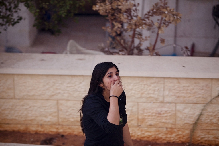 israeli girl looks at a fire