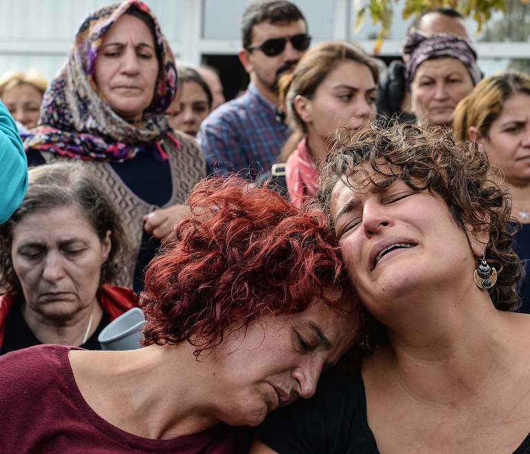 ANKARA, TURKEY - OCTOBER 11: Family members of Korkmaz Tedik, a victim of Saturday's bomb blasts, react as they mourn during a funeral ceremony in Ankara, October 11, 2015 Turkey. Thousands of people, many chanting anti-government slogans, gathered in central Ankara on Sunday near the scene of bomb blasts which killed at least 95 people, mourning the victims of the most deadly attack of its kind on Turkish soil. Police insisted investigators were still working at the site. Turkish PM Davutoglu declares three days of national mourning over Ankara bomb attacks. (Photo by Gokhan Tan/Getty Images)