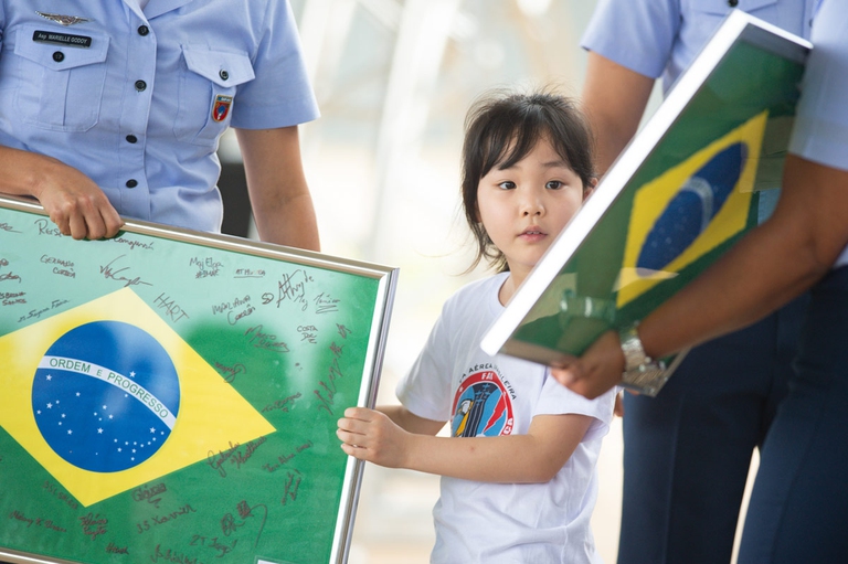 Primo caso di coronavirus in Brasile bambina con andiera brasile guarda verso telecamera