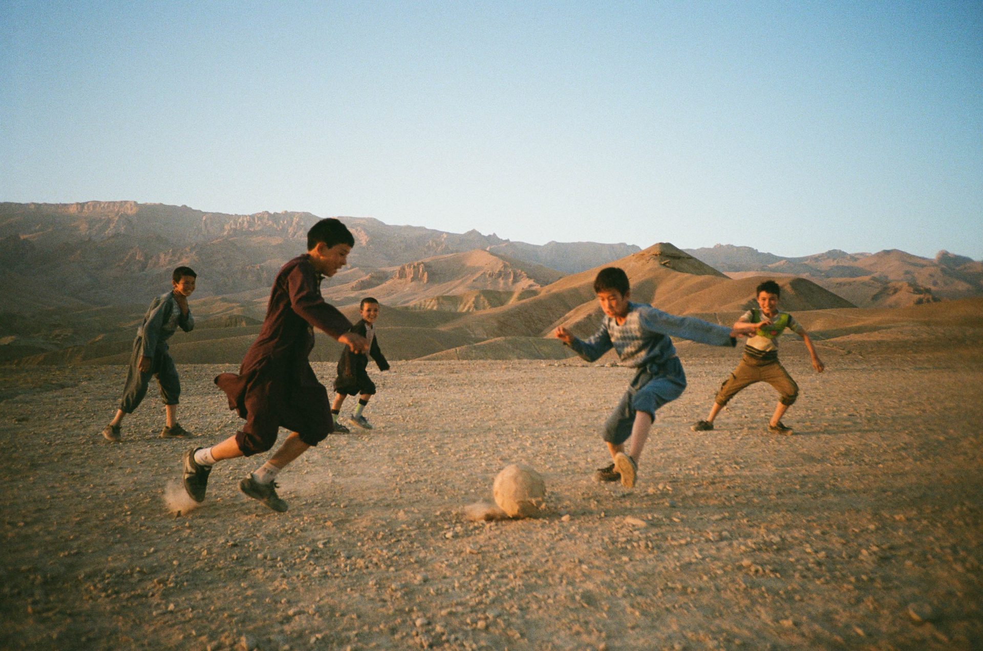 11 - Boys play by the Buddhas at dusk, Nick Curran