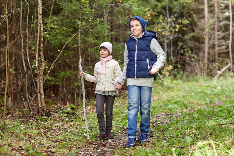 Due bambini passeggiano in un bosco