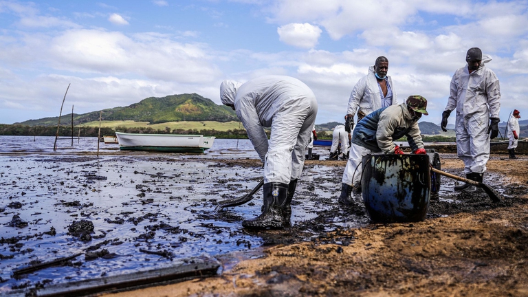 volunteers clean up oil spill in Mauritius