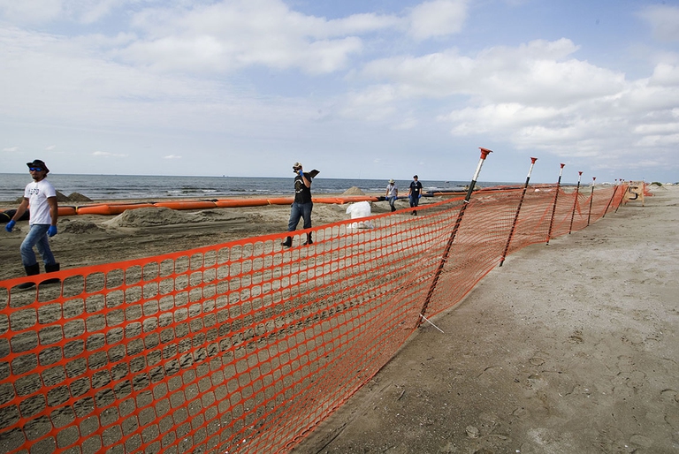 Lavoratori assunti da BP durante un tour di pulizia della spiaggia. I lavoratori ruotano per 20 minuti per evitare disagi dovuti al calore. Grand Isle, Louisiana. ©Giada Connestari