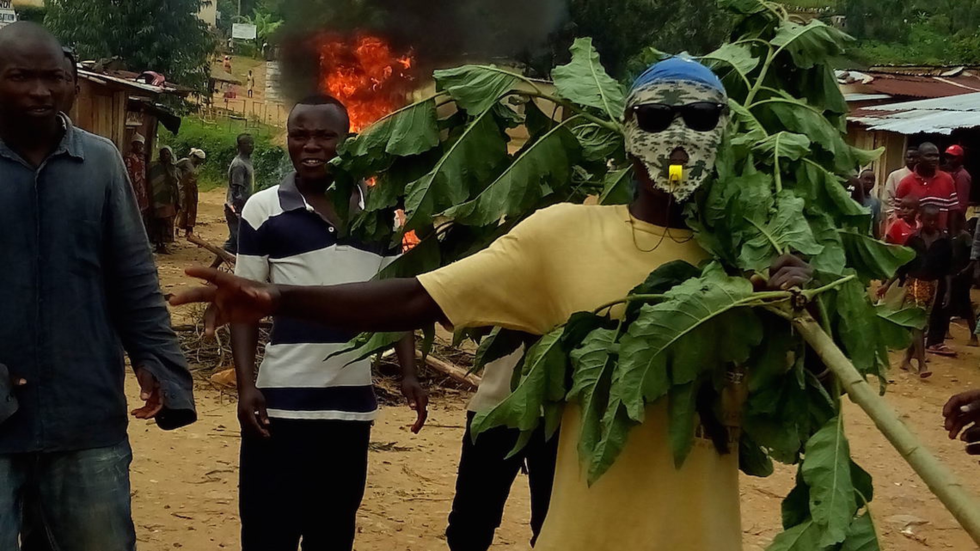 masked-protester-with-branch