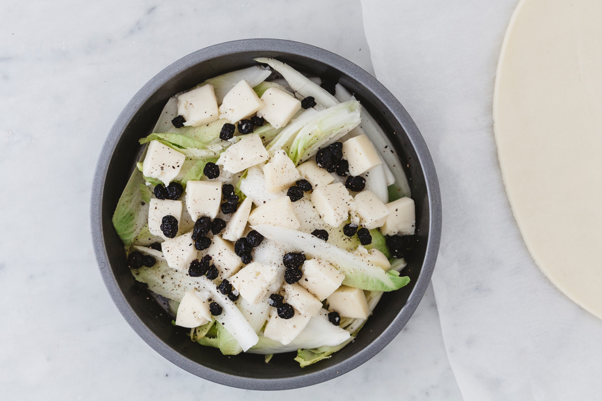 Tarte tatin con insalata belga, taleggio e mirtilli