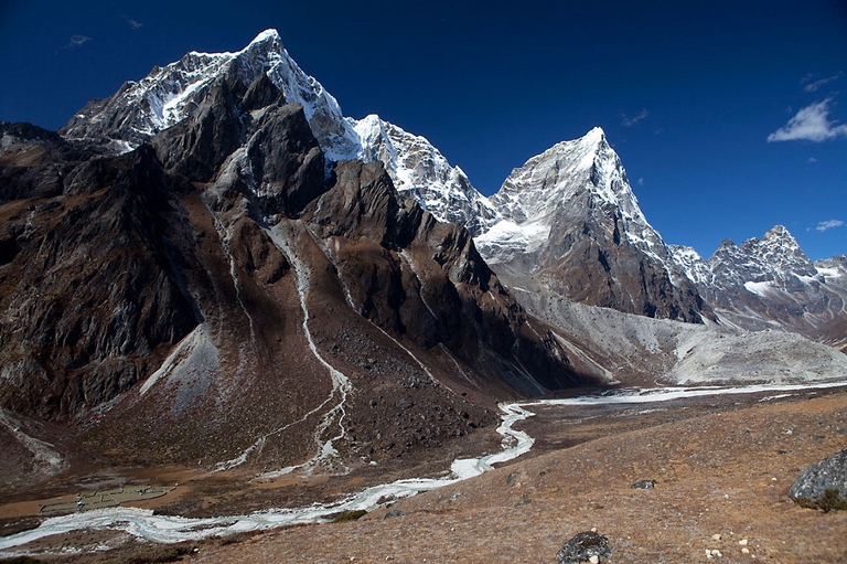 A rubble and debris from a landslide seen from the trail between Dengboche and Tuckla Pass above Pheriche in the Everest region of the Himalayas in Nepal.  The region is currently being severely affected by climate change including an increased risk to human life from Glacial Lake Outburst Floods (GLOFS) caused by the accelerated melting of glaciers to form glacial lakes which continue to swell dangerously beyond ther natural ability to drain safely. Bad weather, seismic activity (common in the area), and lansides, like the one seen here can all act as triggers for these floods.. The Sherpa people who live in the valleys and communities below stand to lose both their lives and their livelihoods should this happen. With a recent history in the area of other catastrophic Glacial Lake Outburst Floods the local people know all too well the constant threat that hangs over them.
