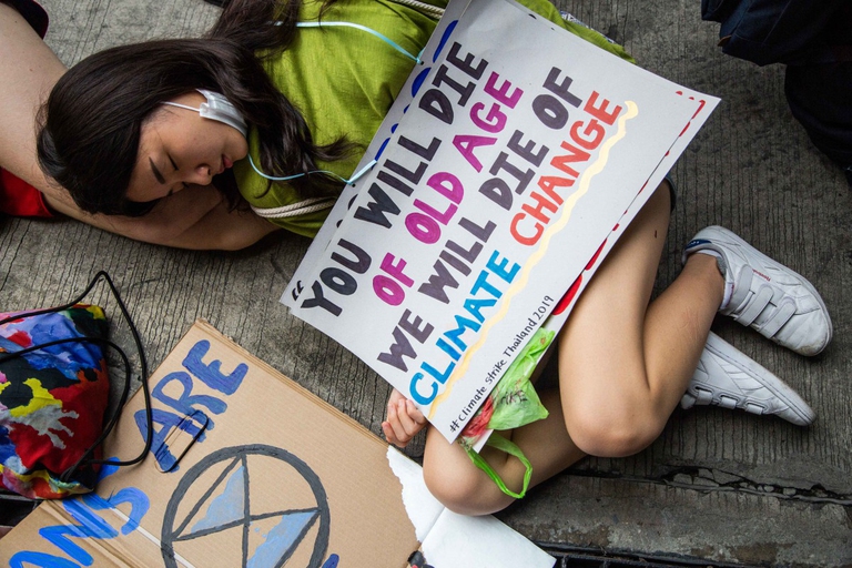 BANGKOK, THAILAND - SEPTEMBER 20:  Thai people take part in a "die-in", where strikers lie on the ground and pretend to die, symbolising the impact of climate change in front of the Ministry of Natural Resources and Environment on September 20, 2019 in Bangkok, Thailand. Hundreds of Thai students, adults and foreigners joined together on Friday as part of a global mass day to demand action on climate change. The movement was inspired by Swedish teenager and climate activist, Greta Thunberg. Climate Change Bangkok delivered an open letter to the Ministery of Natural Resources demanding the government declare a climate emergency and commit to complete the phasing out of coal. (Photo by Lauren DeCicca/Getty Images)