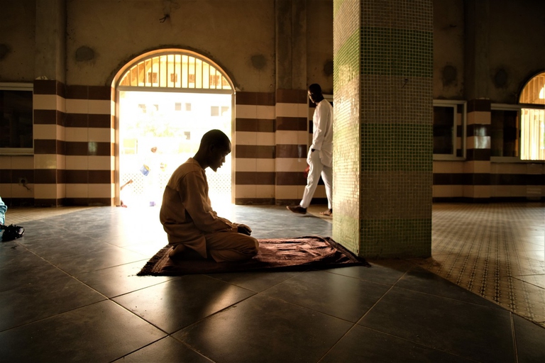 A man praying in Ouagadougou's central mosque