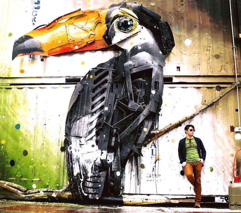 Ben Mirin appassionato di fauna selvatica vicino a un'opera artistica di Berlino che ritrae un tucano