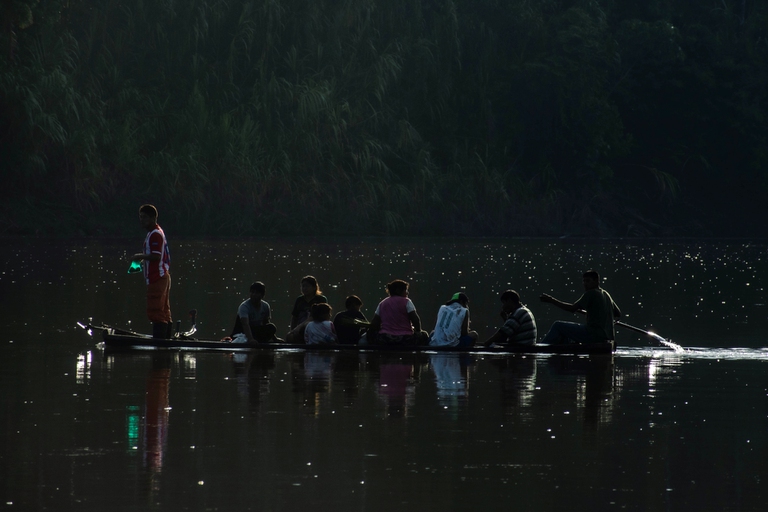 Yuqui inhabitants crossing the Chimoré river in canoe