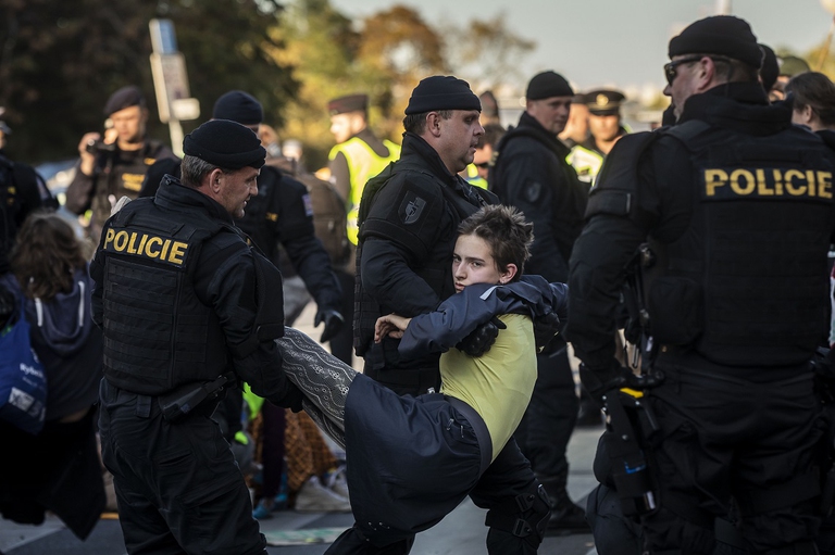 Police officers remove protesters who were blocking a street