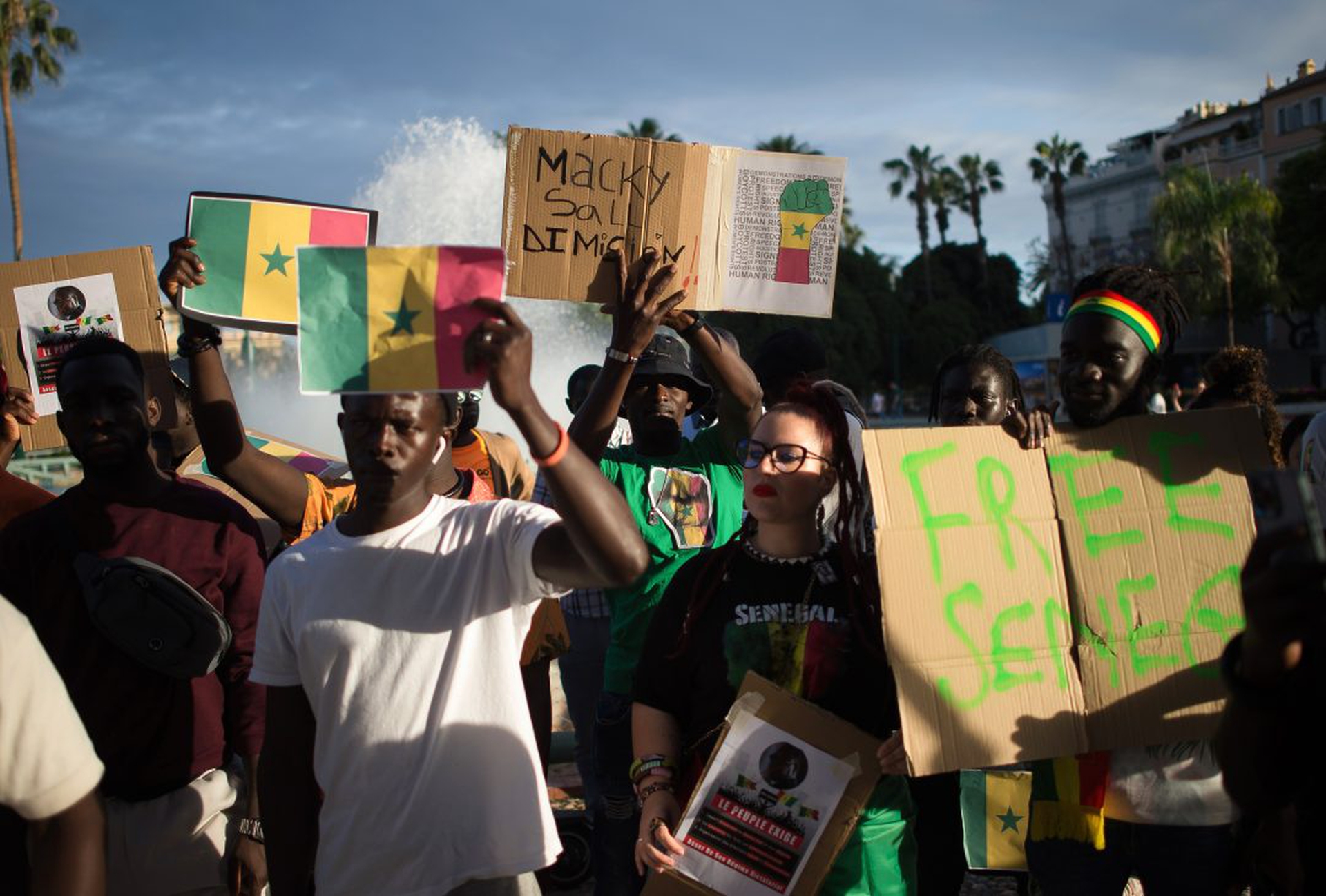 Protesters are seen holding placards and shouting slogans