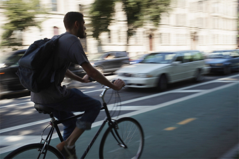 NEW YORK, NY - AUGUST 17:  A man rides his bike along a controversial bike lane next to Prospect Park on August 17, 2011 in New York City. In what is being viewed as a victory for the Bloomberg administration, a judge on Tuesday dismissed an effort by Brooklyn residents to remove a bicycle lane installed by the city on Prospect Park West. Mayor Michael Bloomberg, along with his transportation commissioner, Janette Sadik-Khan, has attempted to make New York more bicycle and pedestrian friendly with numerous bike and pedestrian lanes around Manhattan effort has angered some in the city who see the lanes as adding to traffic, taking up parking spaces and giving more power to bicyclists.  (Photo by Spencer Platt/Getty Images)