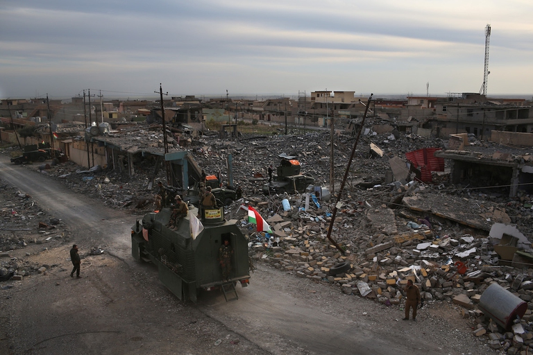 SINJAR, IRAQ - NOVEMBER 15:  Peshmerga forces take positions on November 15, 2015 in Sinjar, Iraq. Kurdish forces, with the aid of massive U.S.-led coalition airstrikes, liberated the town from ISIL extremists, known in Arabic as Daesh, in recent days. Although many minority Yazidis celebrated the victory, their home city of Sinjar lay in almost complete ruins. Local Yazidi fighters wo fought with Kurdish forces and some former residents have been taking any salvagable items out of the rubble, the town being uninhabitable and perilously close to the frontline.  (Photo by John Moore/Getty Images)