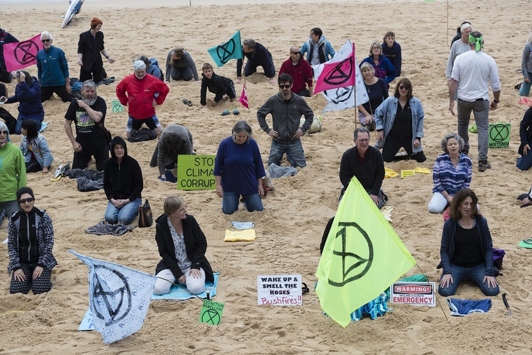 Australian XR activists bury their heads in the sand