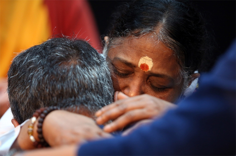 Mata Amritanandamayi con un devoto. La forza carismatica di Amma passa per il suo abbraccio