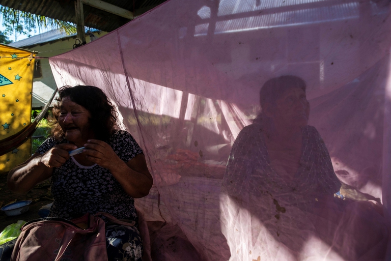 Yuqui women, sisters and mosquito net in the village of Bía Recuaté, Bolivia.