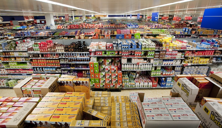 Aisle after aisle of fully stocked shelves at a typical supermarket in the UK. Many baked, frozen, confection, cereal, frozen fish and meat products as well as cosmetics and household cleaning products containg a surprising amount of Palm Oil.