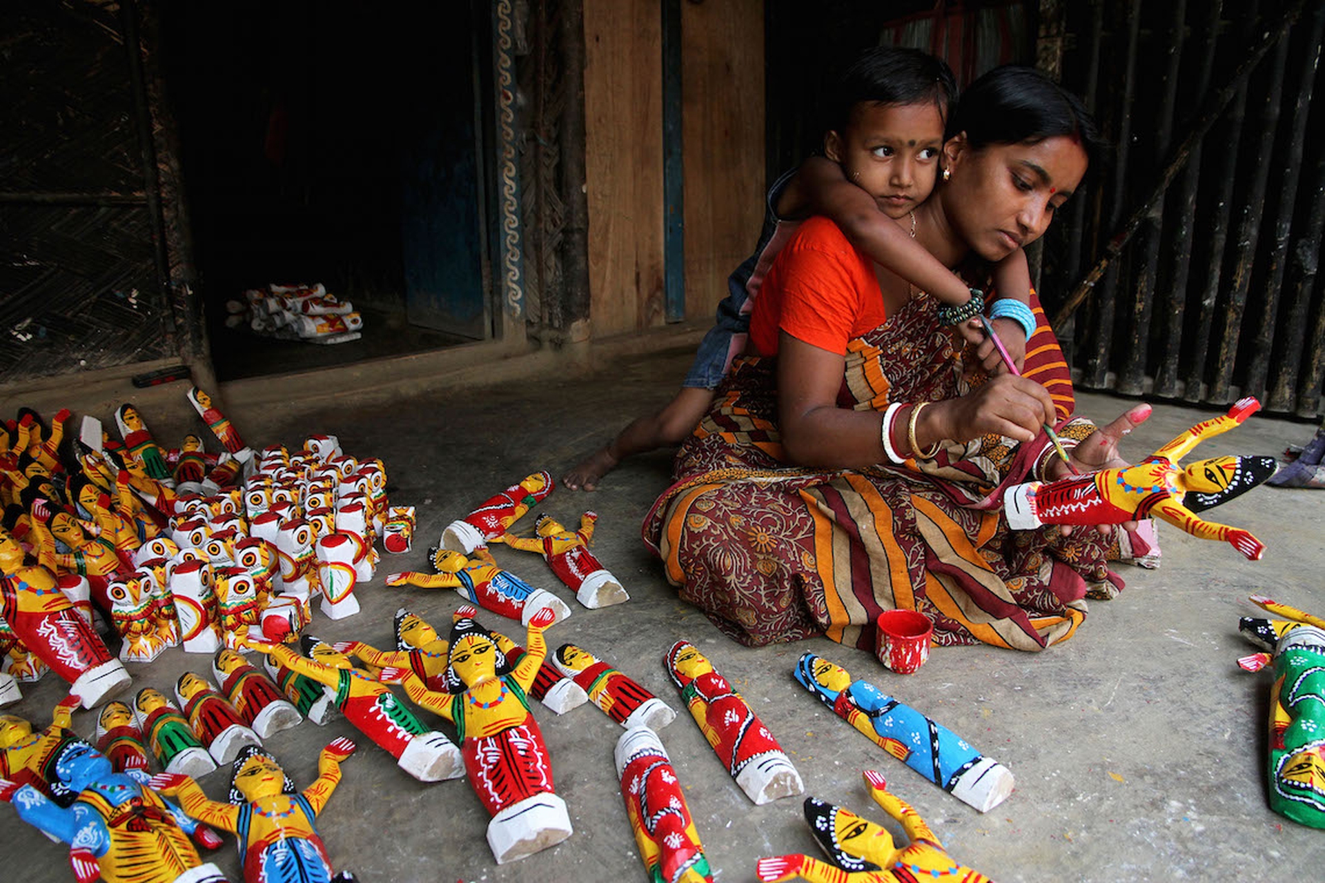 Young Mother is Making a Wooden Doll_SA Prize