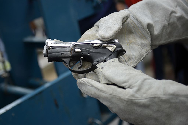 A seized pistol rendered useless during a weapon destruction operation is shown in Caracas on May 20, 2013. AFP PHOTO/Leo RAMIREZ (Photo credit should read LEO RAMIREZ/AFP/Getty Images)