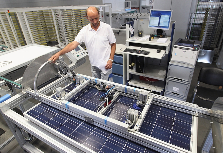 germany factory worker building solar panels
