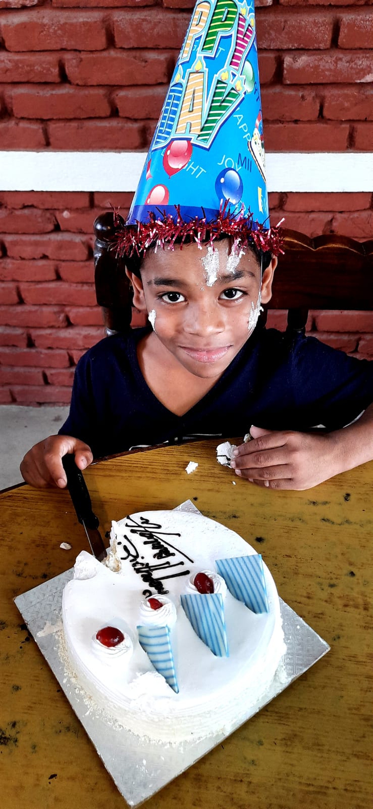A boy celebrating his birthday party at the transit home.