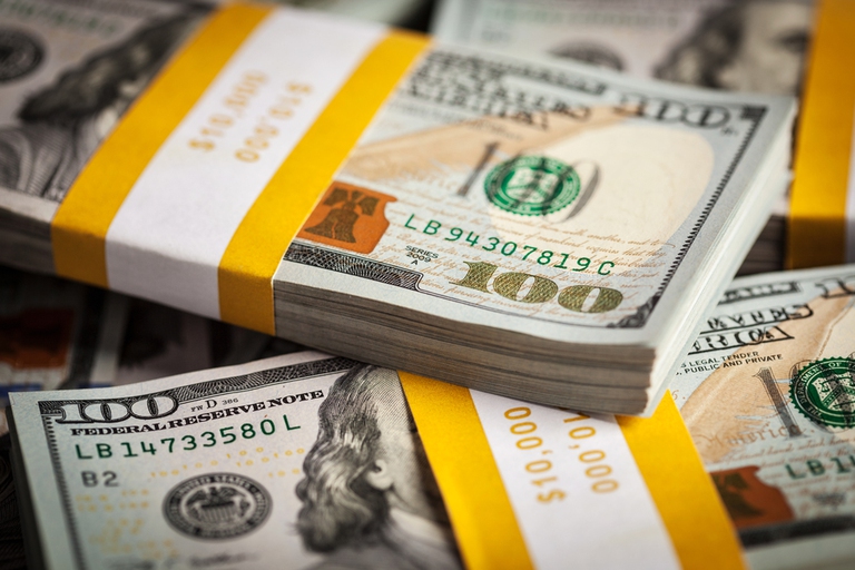 Creative business finance making money concept - background of new 100 US dollars 2013 edition banknotes bills bundles close up